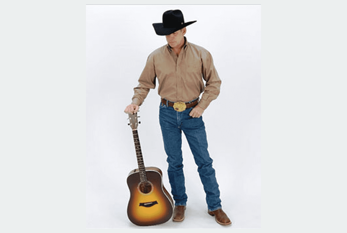 Cowboy with guitar on white background